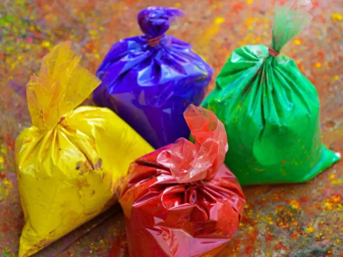 Vibrant colored plastic bags filled with powders, perfect for festivals like Holi.